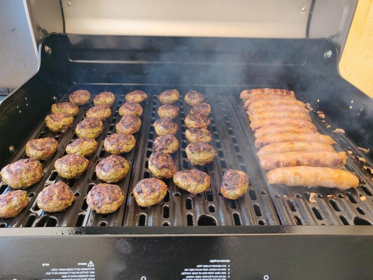 High angle view of meat on barbecue grill